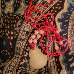 White jade Buddah necklace.
